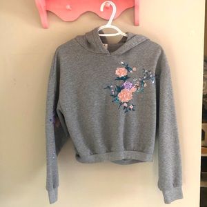Woman’s grey sweater with flowers